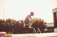 Image of a child jumping into a pool